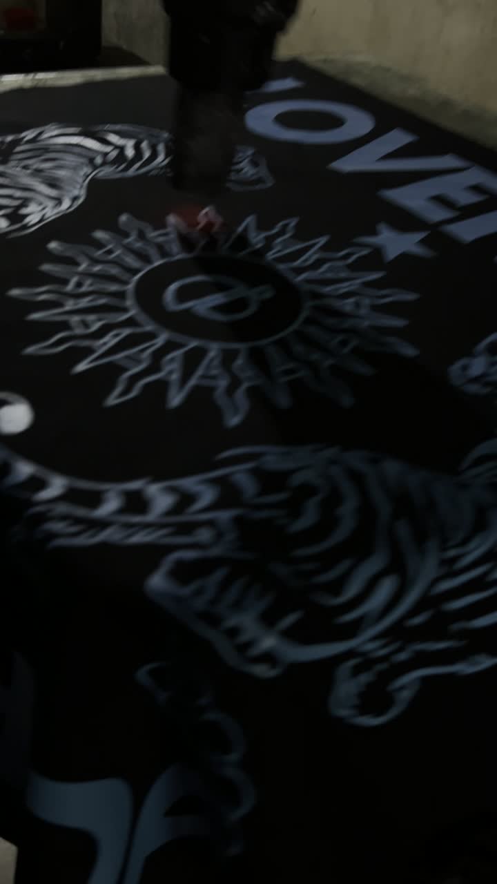 Screen-printing the tiger and sun motif onto silk